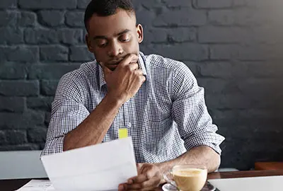 Man with detailed document containing the requirements and legal framework for the process of his denaturalization Man with detailed document containing the requirements and legal framework for the process of his denaturalization