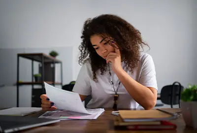 Woman reviewing notifications and documents from a Denaturalization Section Woman reviewing notifications and documents from a Denaturalization Section